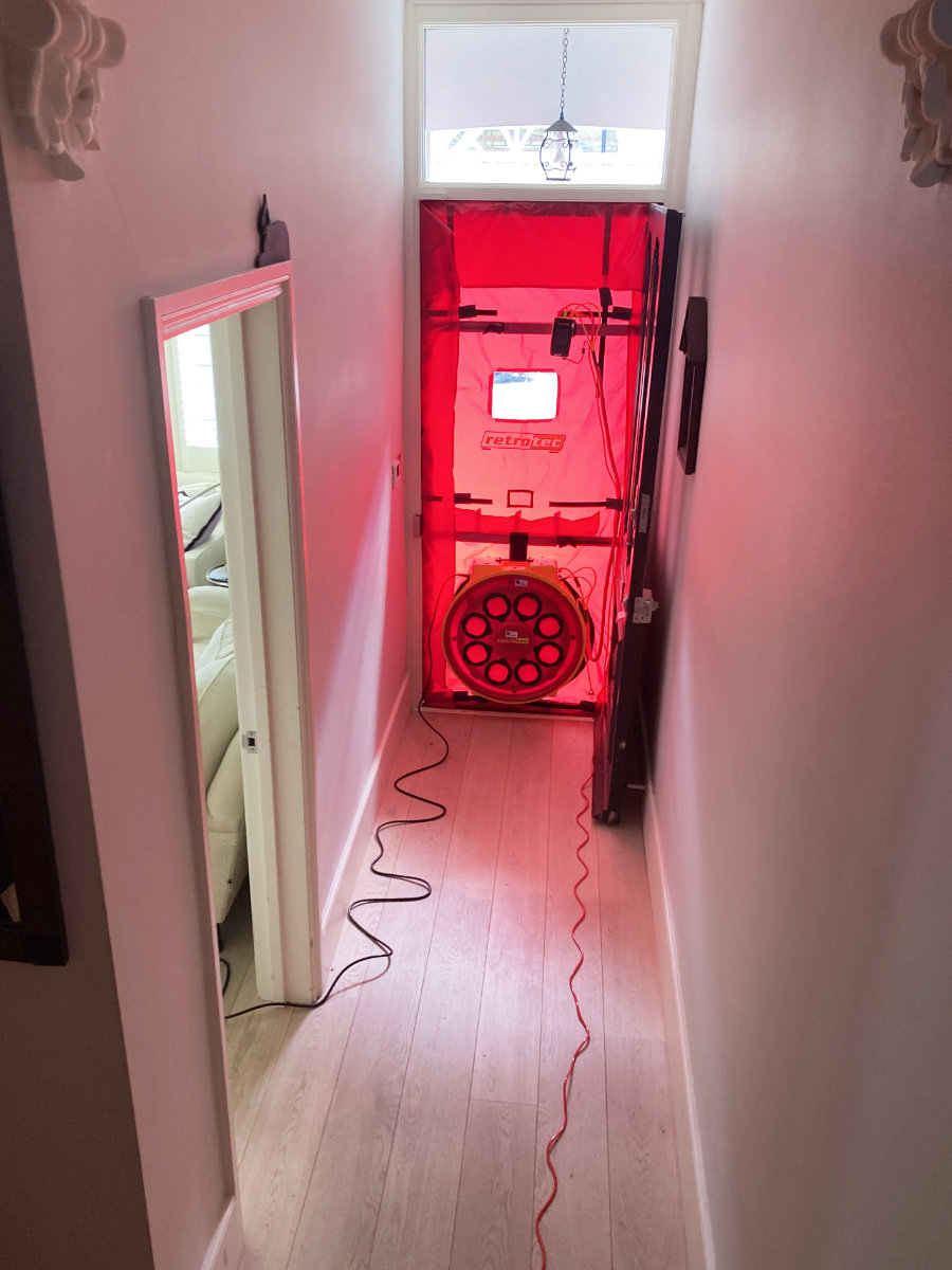 A blower door mounted in a front door opening.